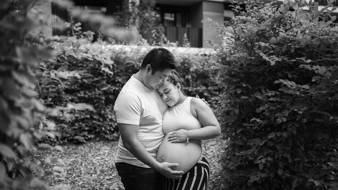 grayscale photo of man and woman kissing